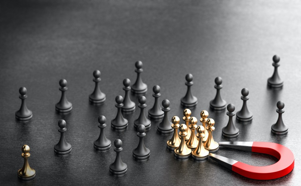 Executive Search Firm: Image of a magnet attracting gold chess pieces over other chess pieces depicting as a trusted search firm to attract the right talent.